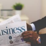 Businessman opening a paper